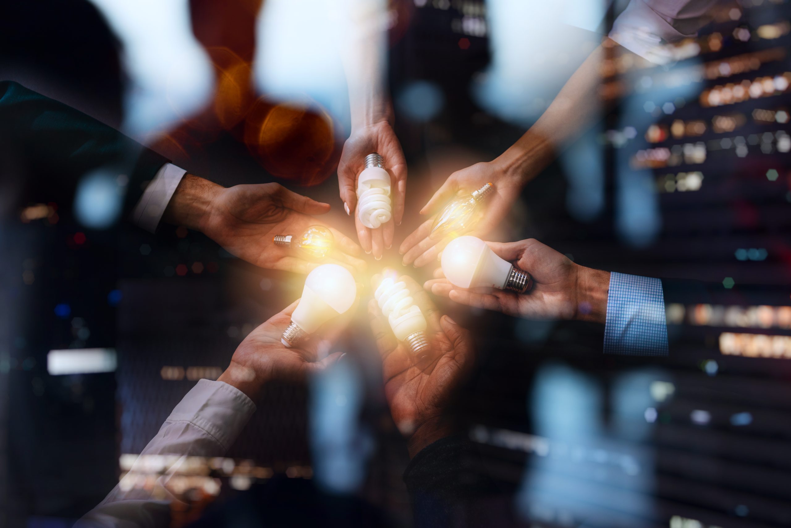 Teamwork and brainstorming concept with businessmen that share an idea with lamps