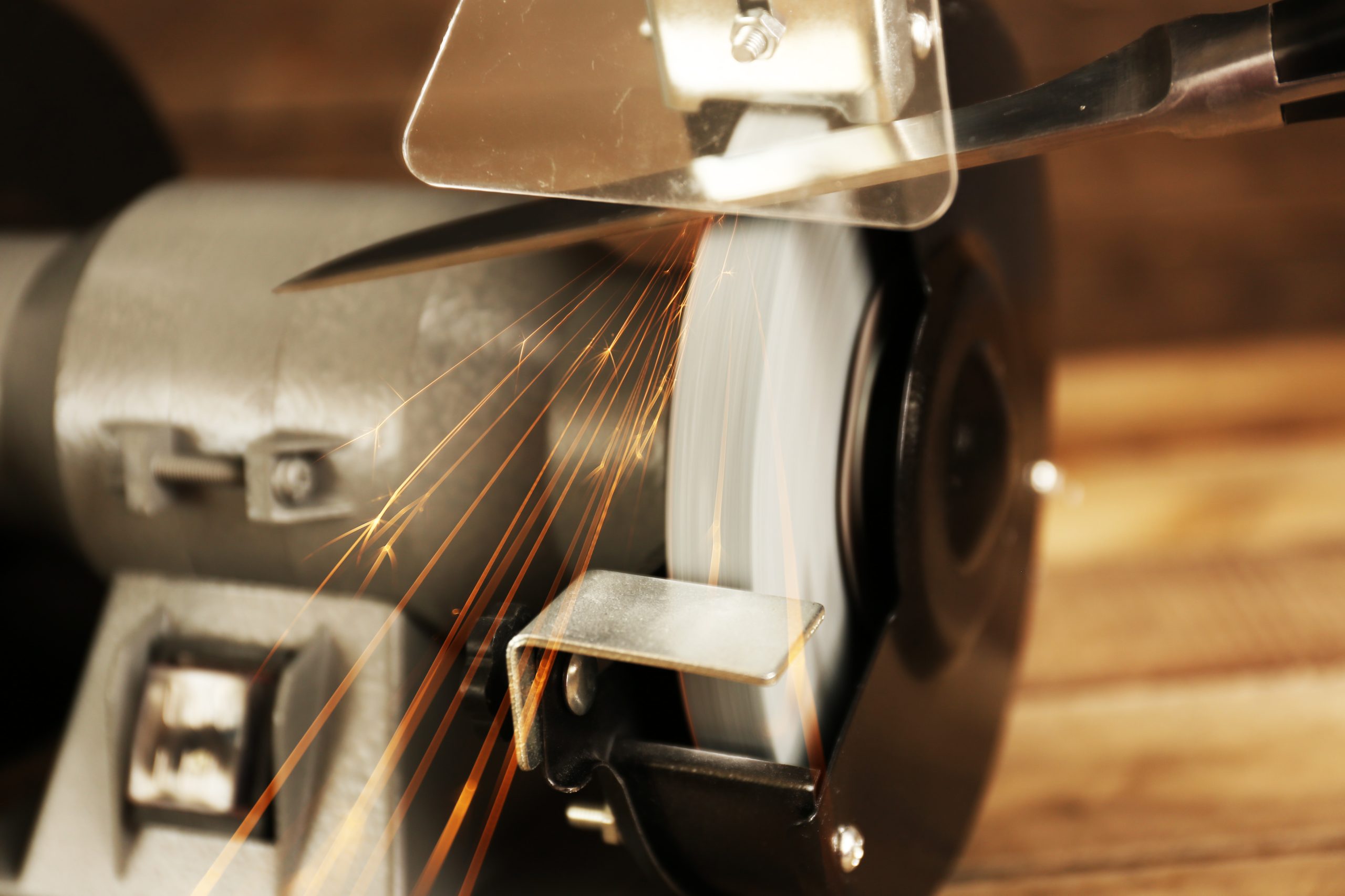 Knife sharpener on wooden table, closeup